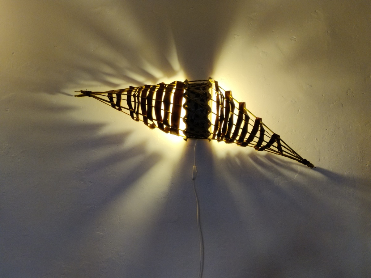 Wall light casting radiating shadows when lit